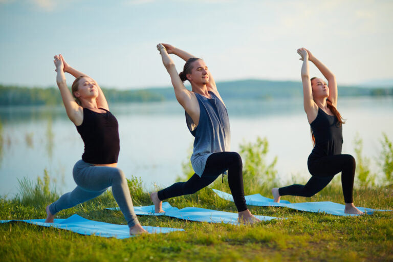 Active people exercising on green grass